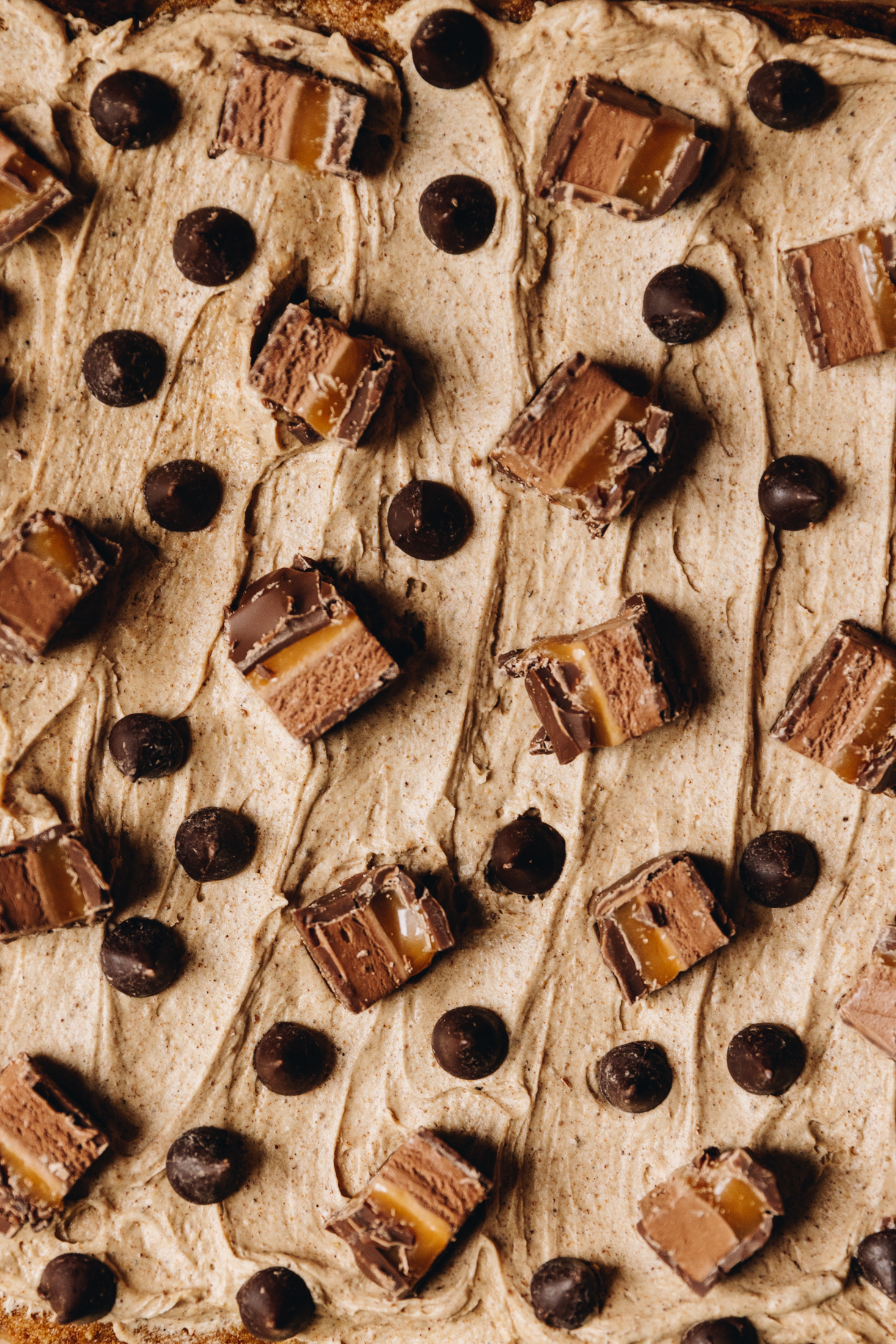 Brown butter frosting topped with mars bar and chocolate drops.