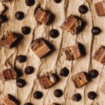 Brown butter frosting topped with mars bar and chocolate drops.