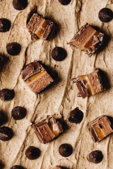 Brown butter frosting topped with mars bar and chocolate drops.
