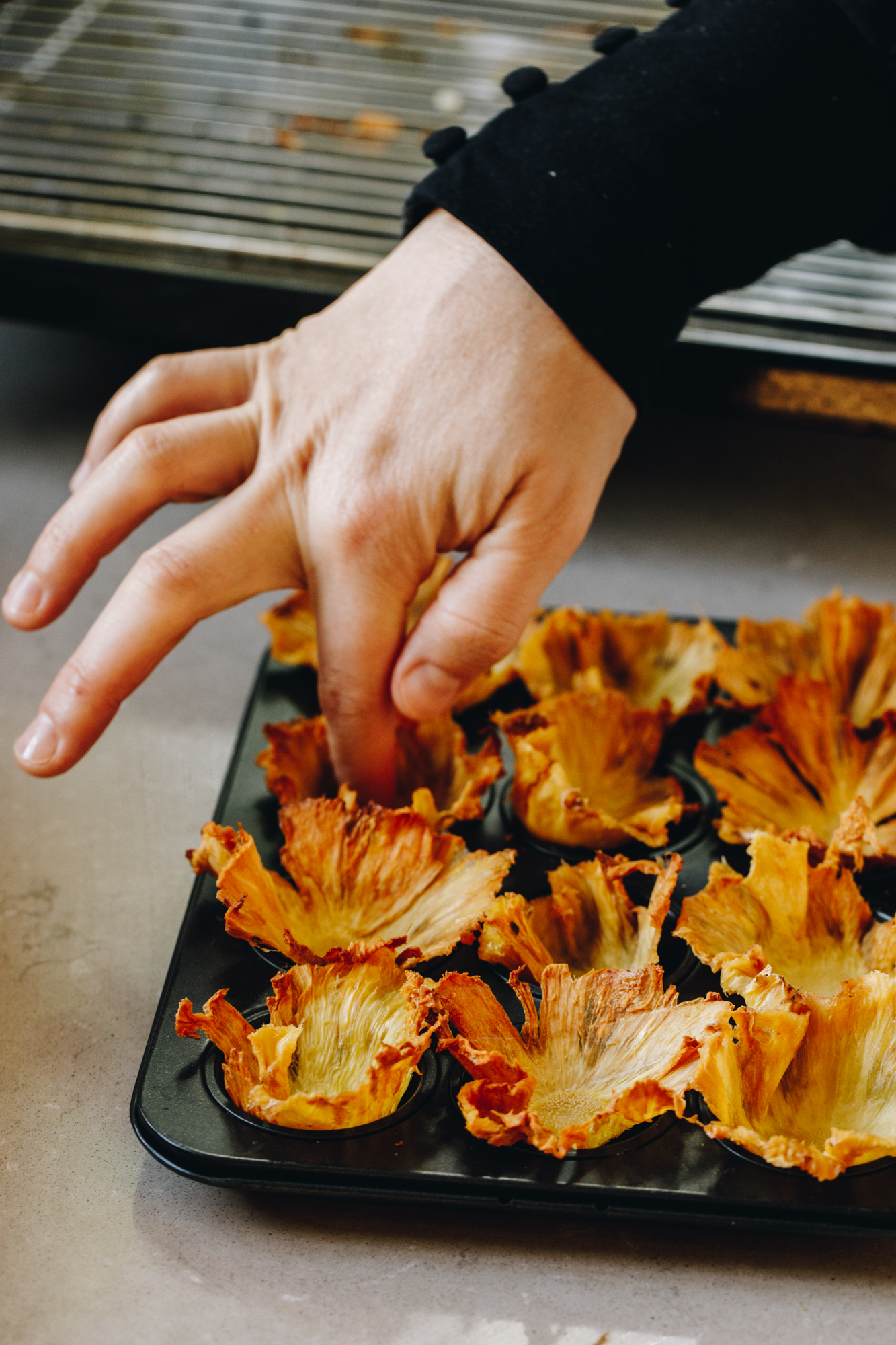Dried pineapple pressed in to mini muffin trays creating a flower shape.