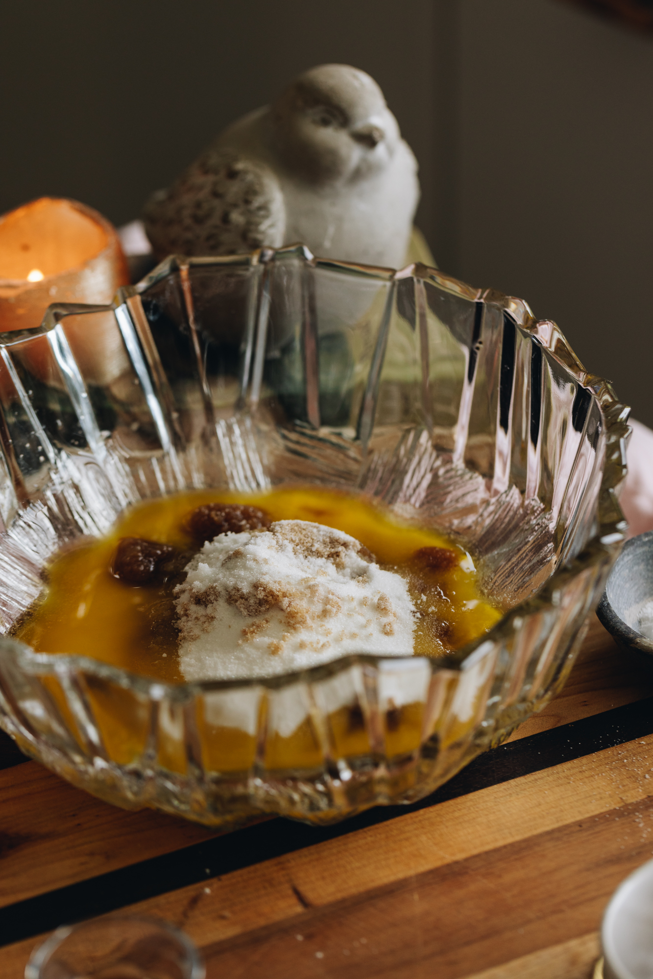 A glass vintage bowl with melted butter, white sugar and brown sugar. 