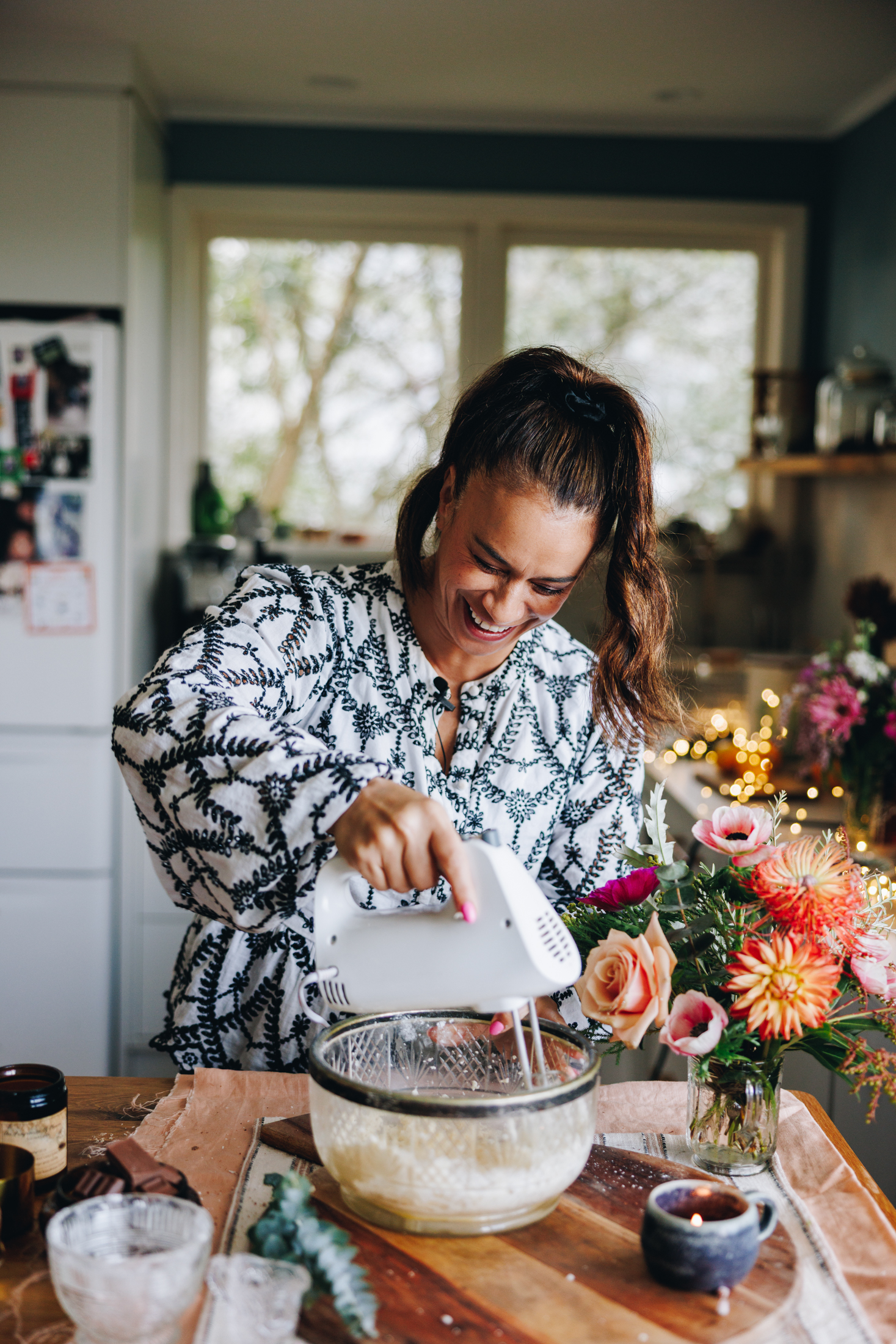 Naomi Toilalo whipping butter in a vintage bowl on a wooden table.