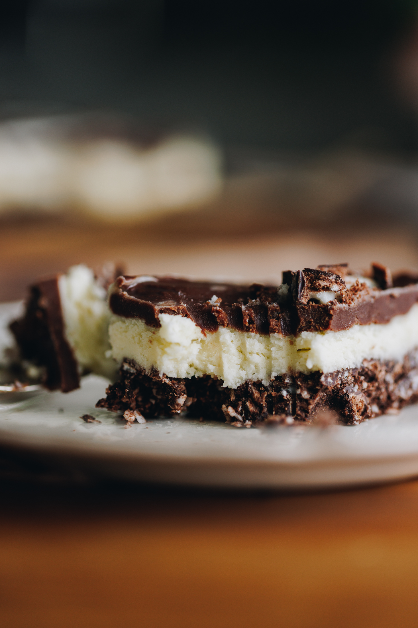 Piece of no-bake mint slice on a plate with a fork mark.