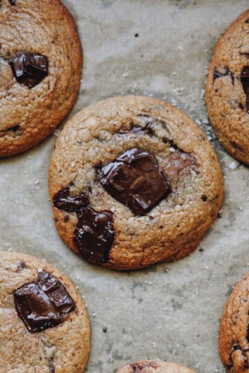 Chocolate hazelnut spread stuffed cookies, baked on a tray lined with baking paper.